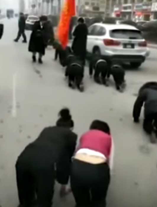 В Китае «недостаточно эффективные» работники проползли на четвереньках по улице